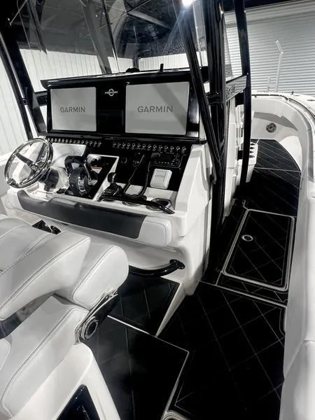 Slide: The Image of 2022 Fountain 34 TE boat cockpit with dual Garmin displays and modern controls. - 14