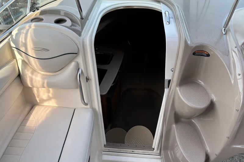 Slide: The Image of 2003 Maxum 2500 SCR boat interior with seating and cabin entrance. - 9