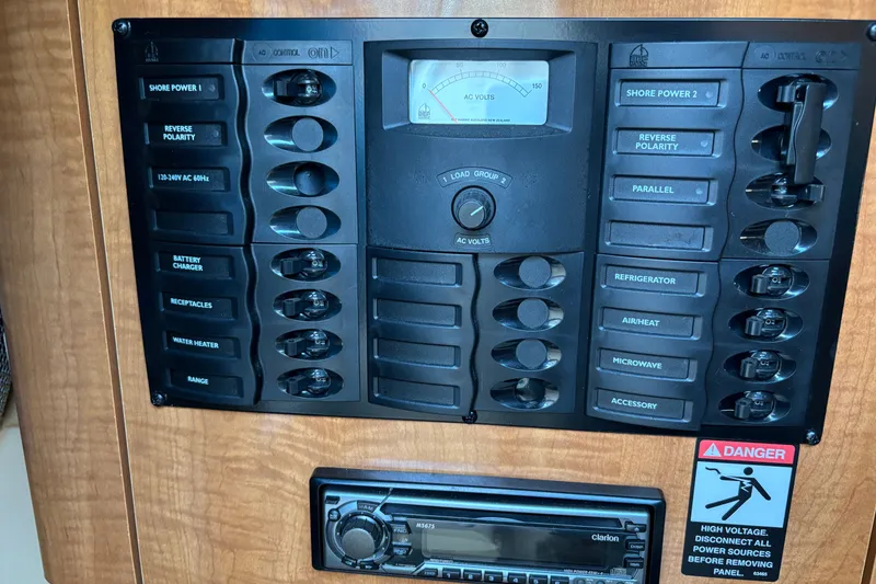 Slide: The Image of Electrical control panel of a 2003 Maxum 2500 SCR boat with various switches and voltmeter. - 16