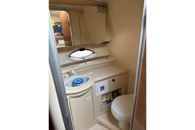 Slide: The Image of 2003 Maxum 2500 SCR boat bathroom with sink, mirror, and toilet. - 13