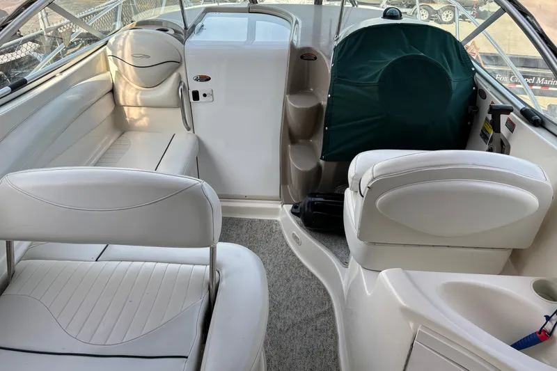 Slide: The Image of 2003 Maxum 2500 SCR boat interior with white seating and helm area. - 3