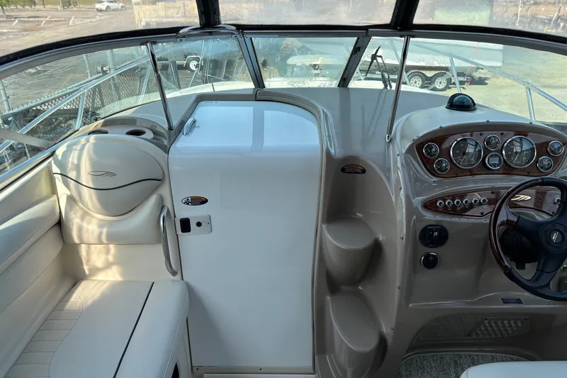 Slide: The Image of 2003 Maxum 2500 SCR boat cockpit with steering wheel and instrument panel. - 8