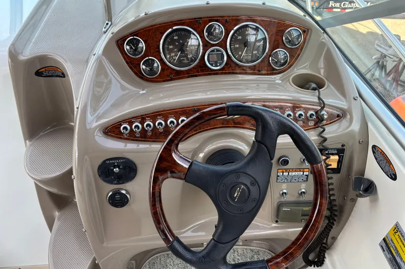Slide: The Image of 2003 Maxum 2500 SCR boat dashboard with wood accents and steering wheel. - 6