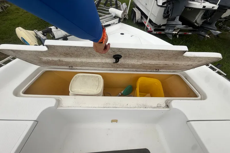 Slide: The Image of Open storage compartment on a 2000 Polar 2100 Center Console boat, containing buckets and equipment. - 21