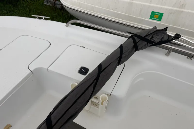 Slide: The Image of 2000 Polar 2100 Center Console boat deck with storage compartments and railing. - 20