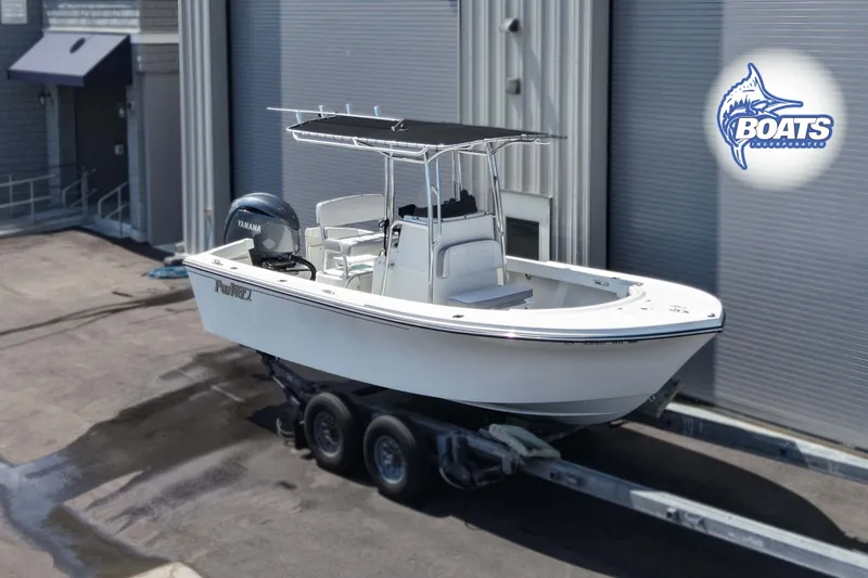 The Image of 2024 Parker 2100 Special Edition boat on trailer, featuring Yamaha engine, parked outside. - 0