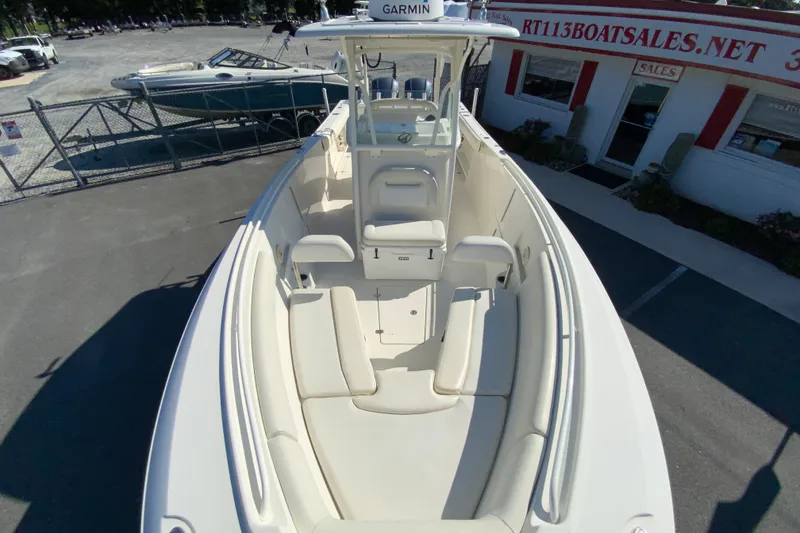 Slide: The Image of 2014 Sailfish 290 CC boat with spacious seating and Garmin equipment at a sales lot. - 26