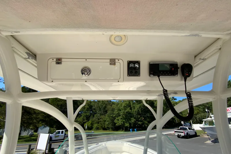 Slide: The Image of 2014 Sailfish 290 CC boat console with radio and storage compartment. - 33