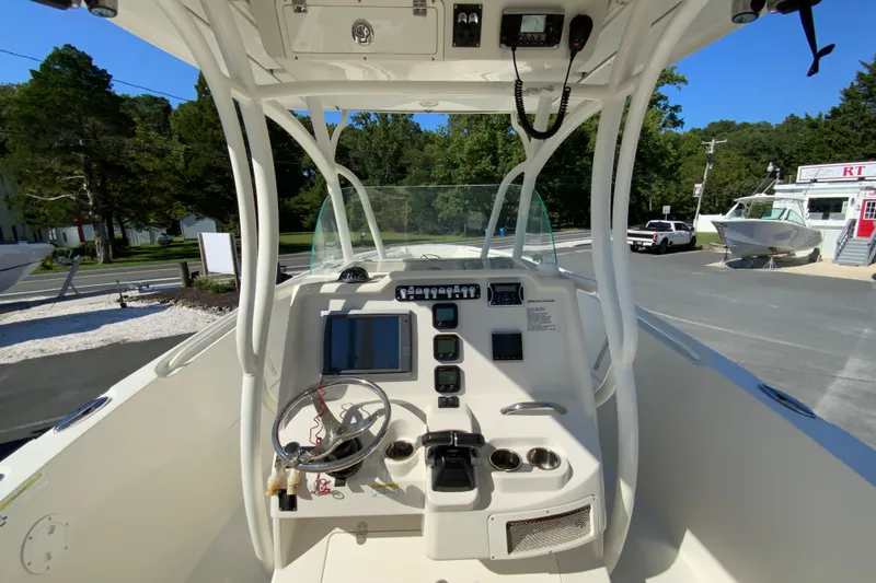Slide: The Image of 2014 Sailfish 290 CC boat cockpit with steering wheel and control panel. - 17
