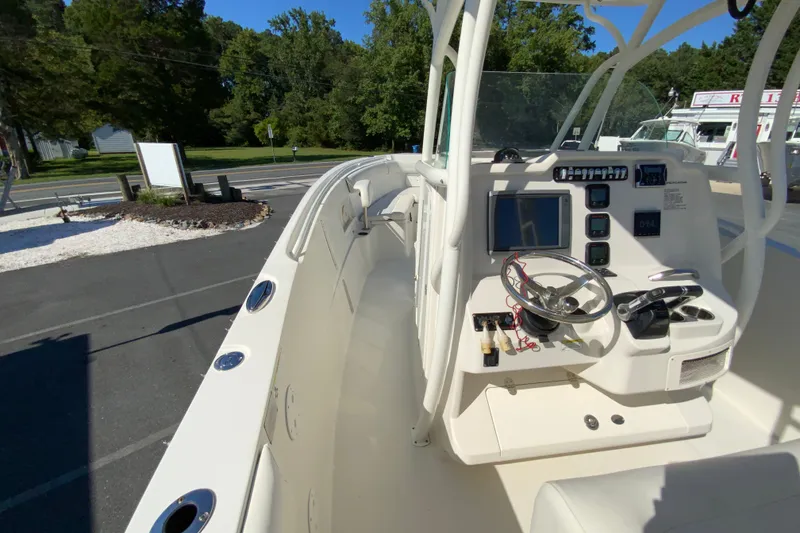 Slide: The Image of 2014 Sailfish 290 CC boat cockpit with steering wheel and control panel. - 22