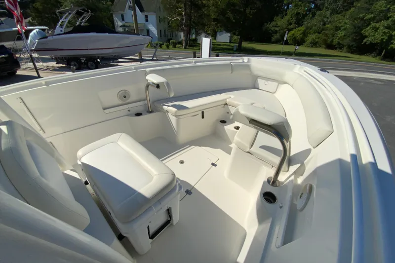 Slide: The Image of 2014 Sailfish 290 CC boat interior with white seating and stainless steel accents. - 24