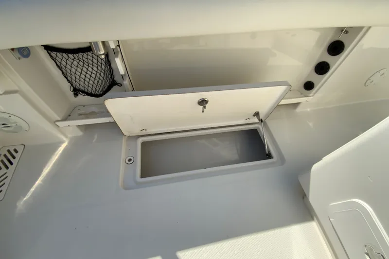 Slide: The Image of Open storage compartment on a 2014 Sailfish 290 CC boat deck. - 35
