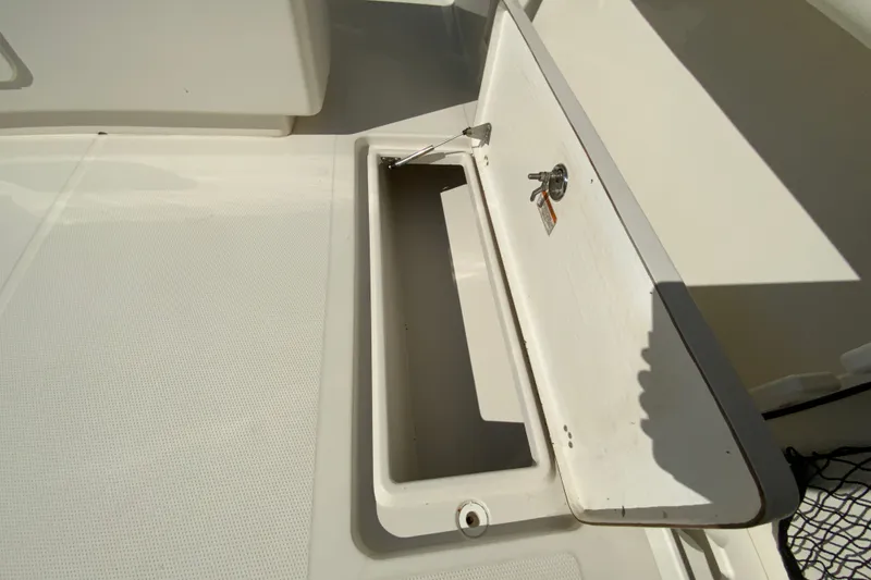 Slide: The Image of Open storage compartment on a 2014 Sailfish 290 CC boat deck. - 36