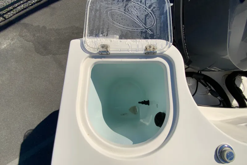 Slide: The Image of Livewell on 2014 Sailfish 290 CC boat, open lid, showing interior and water. - 15