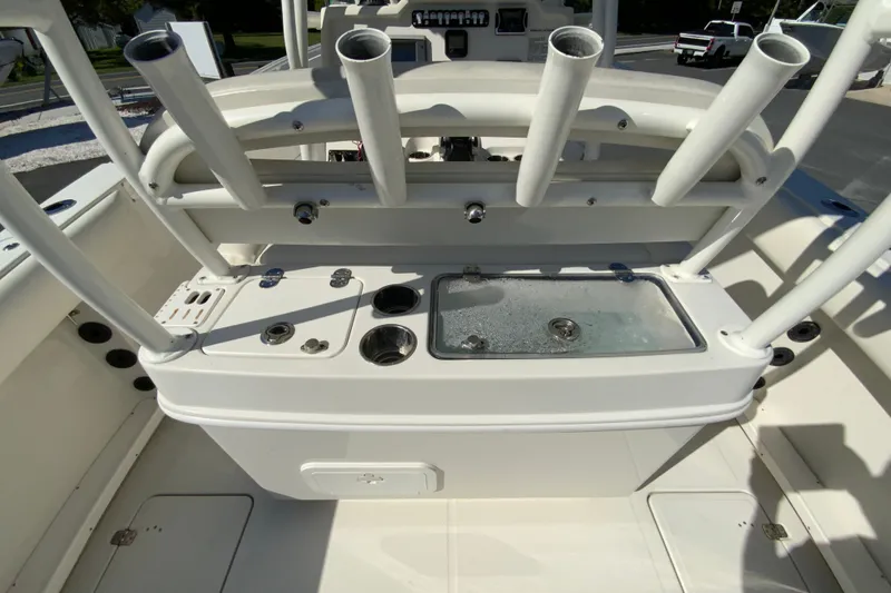 Slide: The Image of 2014 Sailfish 290 CC boat console with rod holders and livewell. - 16