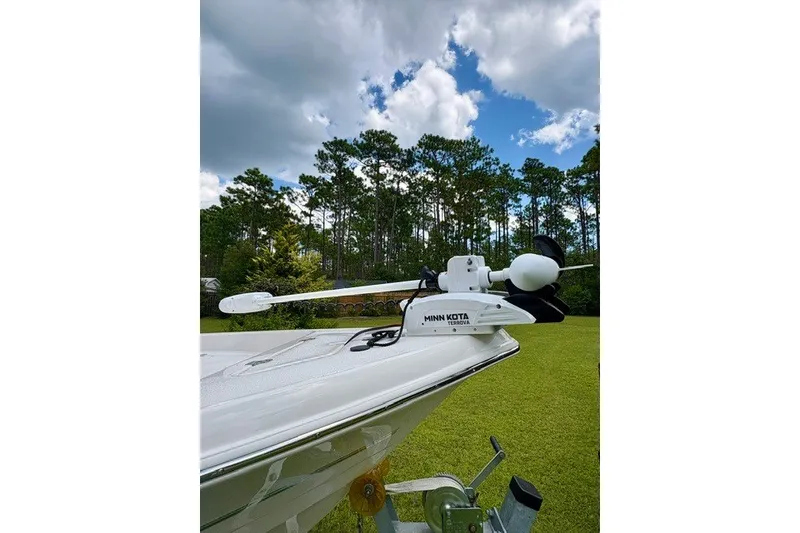 Slide: The Image of Bulls Bay 2000 boat with Minn Kota trolling motor, set against a lush green landscape. - 6