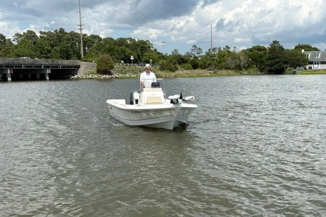 Slide: The Image of Bulls Bay 2000 boat on a calm river, 2026 model, under cloudy sky. - 3