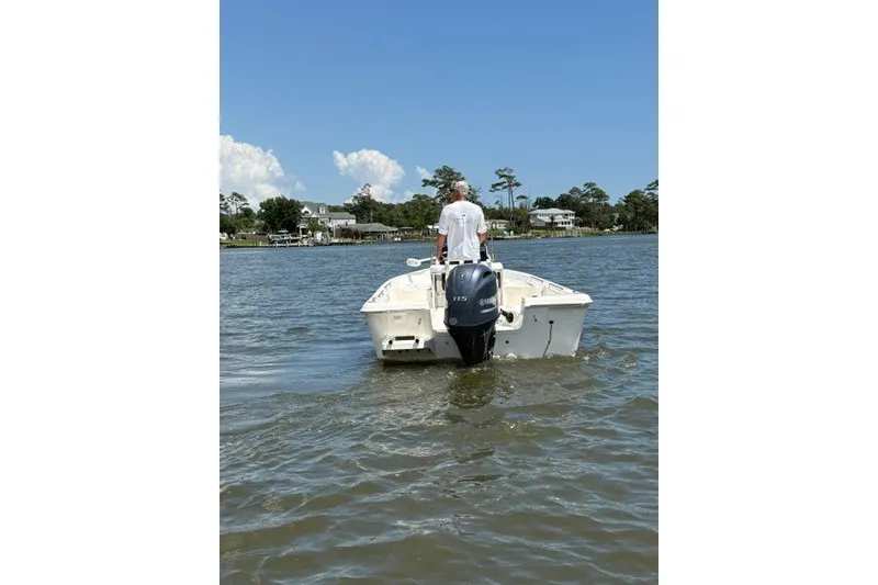 Slide: The Image of Man steering 2026 Bulls Bay 2000 boat on a calm lake. - 1