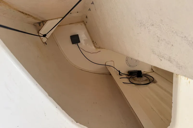 Slide: The Image of Interior view of a 2013 J Boats J/70 sailboat, showcasing wiring and storage space. - 10