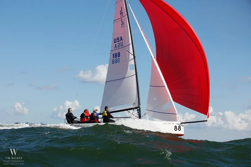 Slide: The Image of Sailing J/70 boat with red spinnaker on open water, 2013 model. - 2