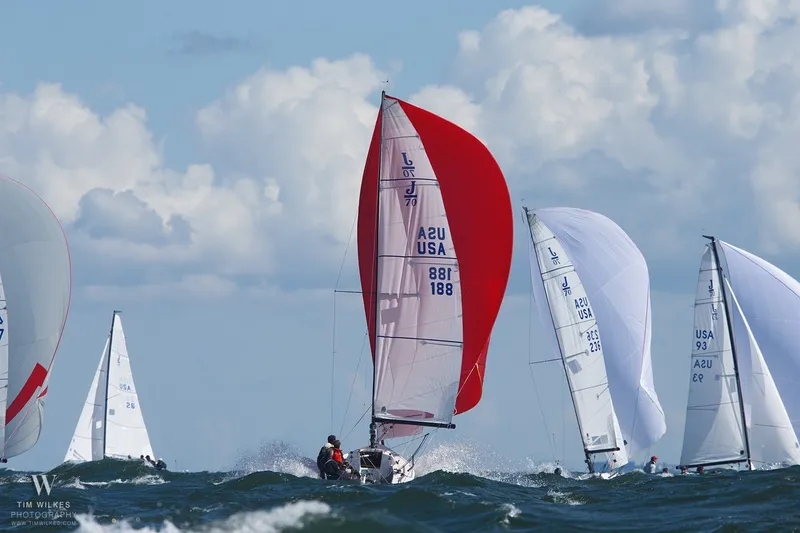 Slide: The Image of Sailboats racing on the ocean, featuring a 2013 J Boats J/70 with red spinnaker. - 18