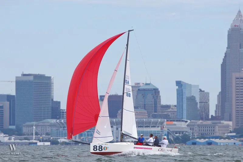 Slide: The Image of Sailboat J/70 with red spinnaker sailing near city skyline, 2013 model. - 17