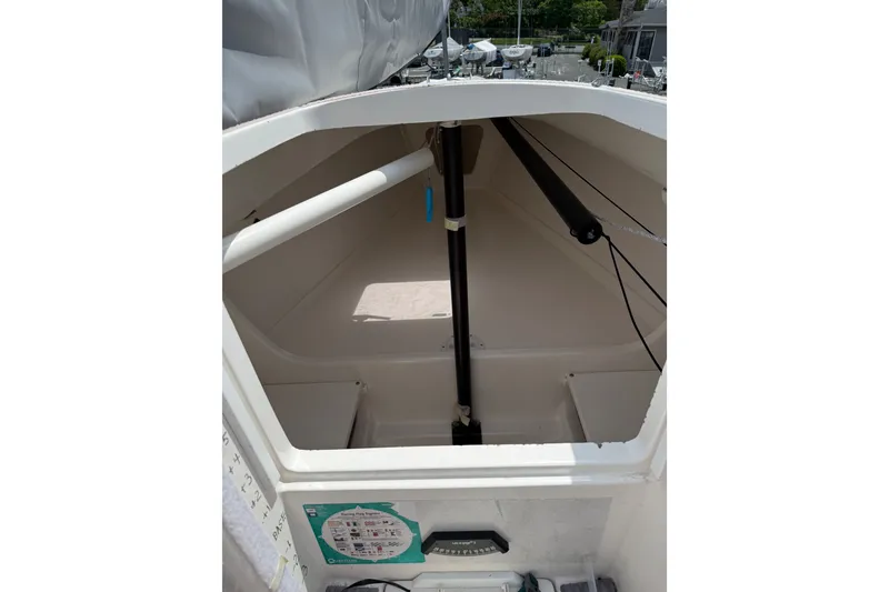 Slide: The Image of Interior view of a 2013 J Boats J/70 sailboat, showcasing storage space and rigging. - 6