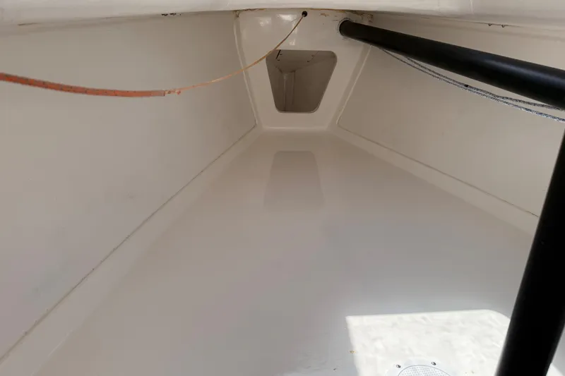 Slide: The Image of Interior view of a 2013 J Boats J/70 sailboat, showcasing clean, white surfaces. - 8