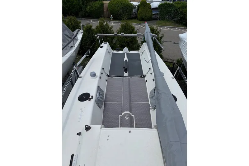 Slide: The Image of 2013 J Boats J/70 sailboat deck with covered mast, parked outdoors. - 5