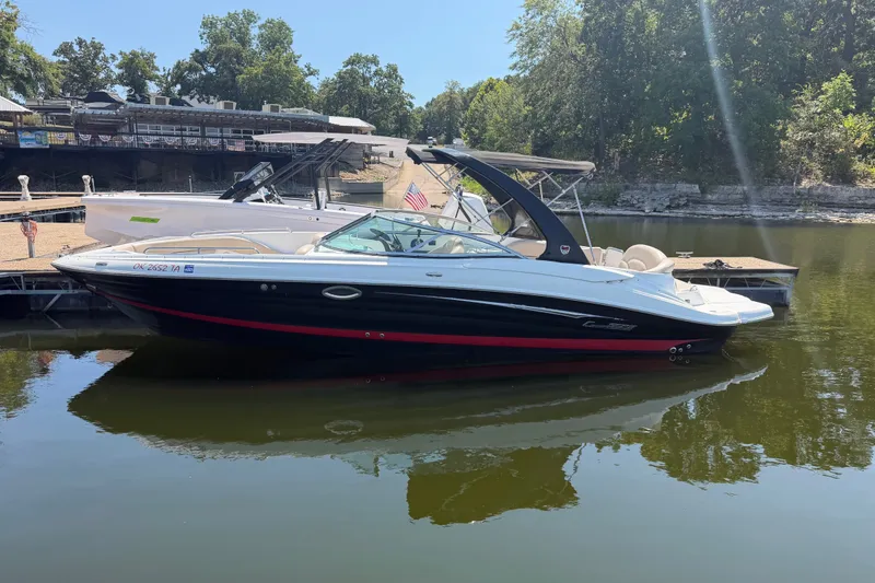 The Image of 2014 Cruisers Sport Series 298 Bow Rider boat docked on a calm lake. - 12
