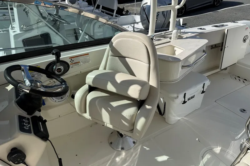 Slide: The Image of 2018 Boston Whaler 230 Vantage boat interior with steering wheel and seating. - 7
