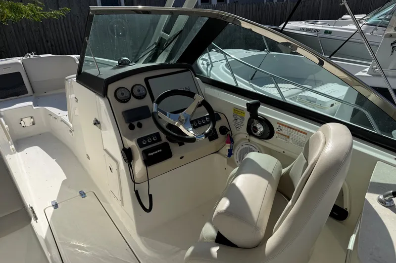 Slide: The Image of 2018 Boston Whaler 230 Vantage boat cockpit with steering wheel and controls. - 6
