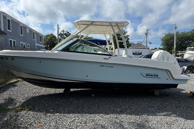 The Image of 2018 Boston Whaler 230 Vantage boat on gravel lot under cloudy sky. - 0