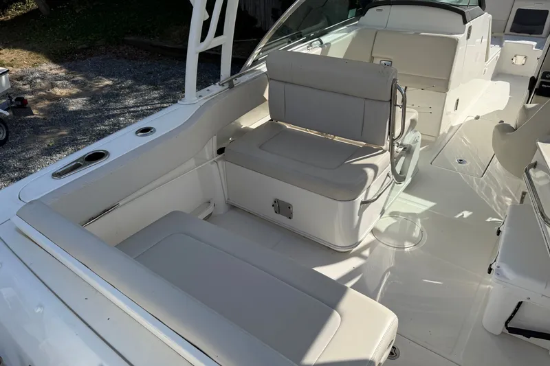 Slide: The Image of 2018 Boston Whaler 230 Vantage boat interior with white seating and clean deck. - 8