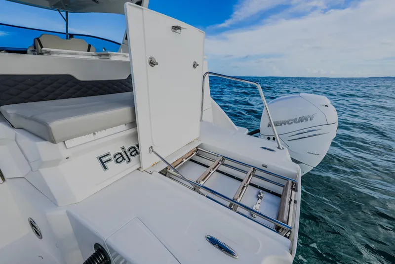 Slide: The Image of 2023 Aquila 36 Sport boat with Mercury engine on open water. - 50