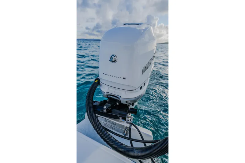 Slide: The Image of 2023 Aquila 36 Sport boat engine on open water, showcasing sleek design and performance. - 49