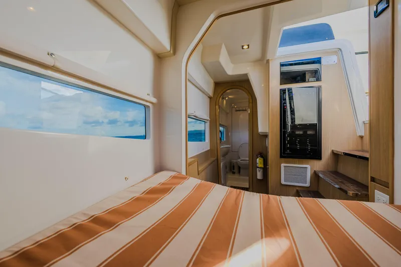 Slide: The Image of Interior of 2023 Aquila 36 Sport yacht with striped bedding and modern amenities. - 47