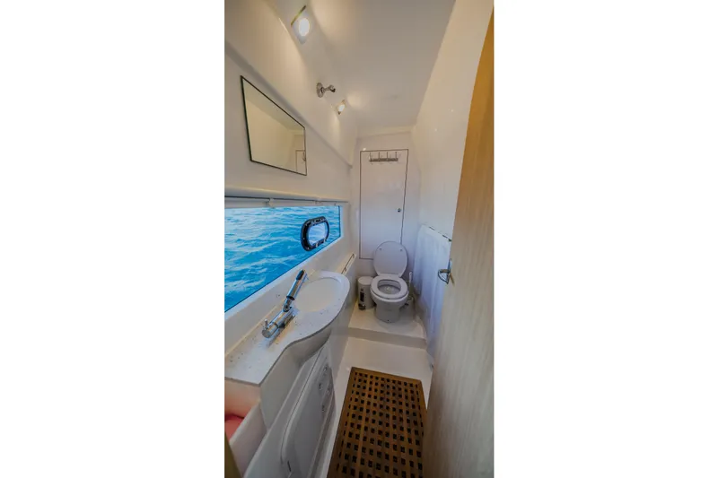 Slide: The Image of 2023 Aquila 36 Sport yacht bathroom with ocean view, modern fixtures, and wooden floor mat. - 44