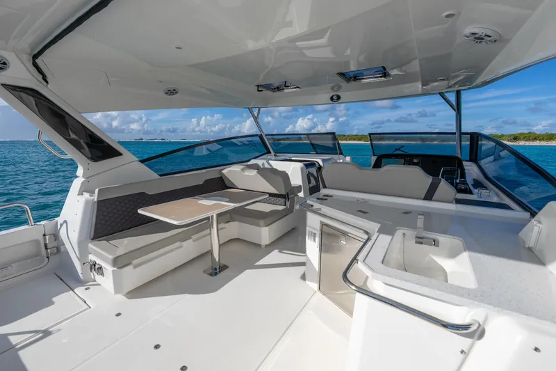 Slide: The Image of 2023 Aquila 36 Sport yacht interior with seating, table, and ocean view. - 17