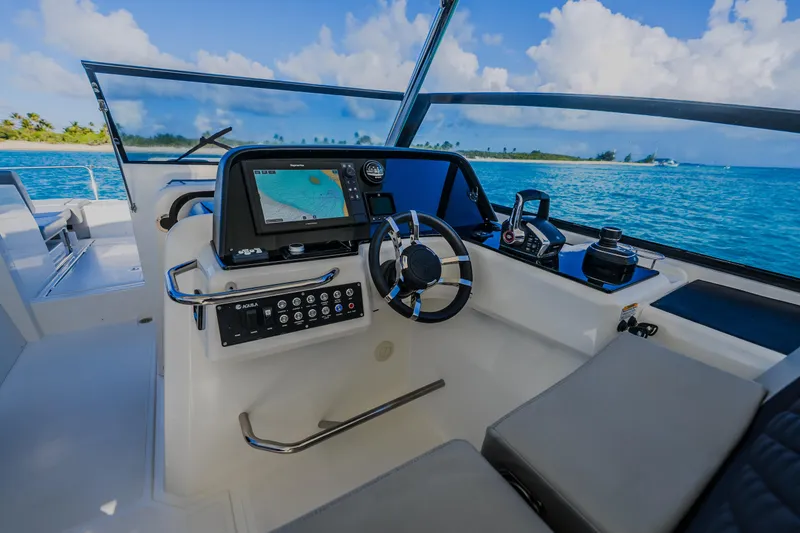 Slide: The Image of Cockpit of 2023 Aquila 36 Sport yacht with navigation system, steering wheel, and ocean view. - 21