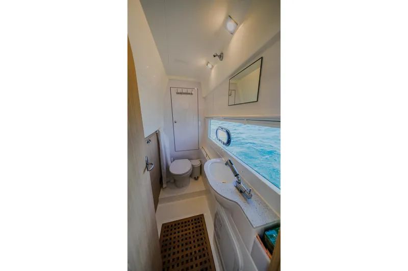 Slide: The Image of 2023 Aquila 36 Sport yacht bathroom with modern fixtures and ocean view window. - 41