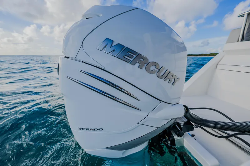 Slide: The Image of Outboard motor on 2023 Aquila 36 Sport boat in ocean setting. - 51