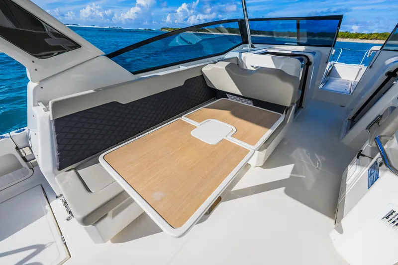 Slide: The Image of 2023 Aquila 36 Sport boat interior with seating and table, ocean view. - 27