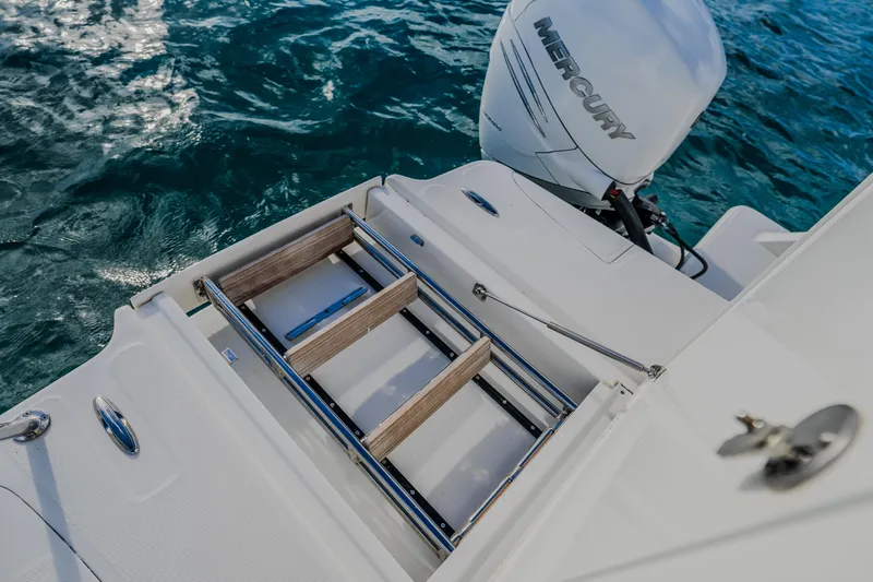 Slide: The Image of 2023 Aquila 36 Sport boat with Mercury engine and swim ladder on blue water. - 53