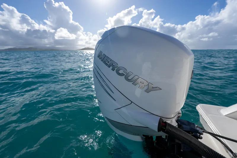 Slide: The Image of 2023 Aquila 36 Sport with Mercury engine on turquoise ocean under blue sky. - 16