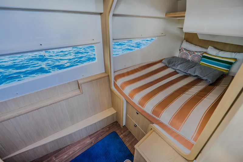 Slide: The Image of Cozy cabin interior of 2023 Aquila 36 Sport yacht with striped bedding and ocean view. - 40