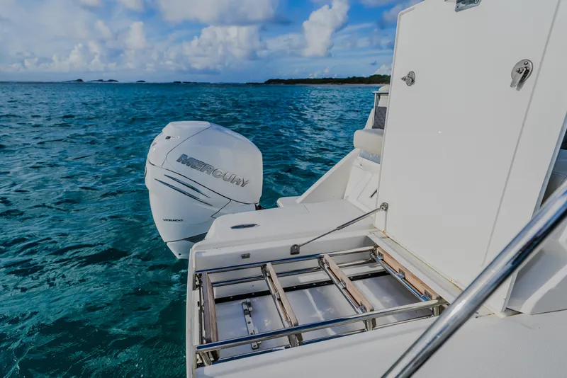 Slide: The Image of 2023 Aquila 36 Sport boat with Mercury engine on blue ocean water. - 54