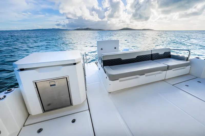 Slide: The Image of 2023 Aquila 36 Sport boat deck with seating, ocean view, and storage compartment. - 52