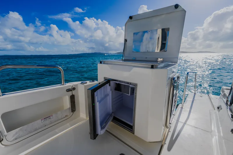 Slide: The Image of 2023 Aquila 36 Sport boat with open storage compartment on deck, ocean view. - 19