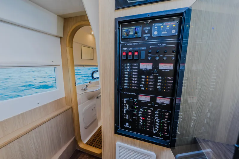 Slide: The Image of Control panel inside 2023 Aquila 36 Sport yacht, featuring modern electrical systems and ocean view. - 48